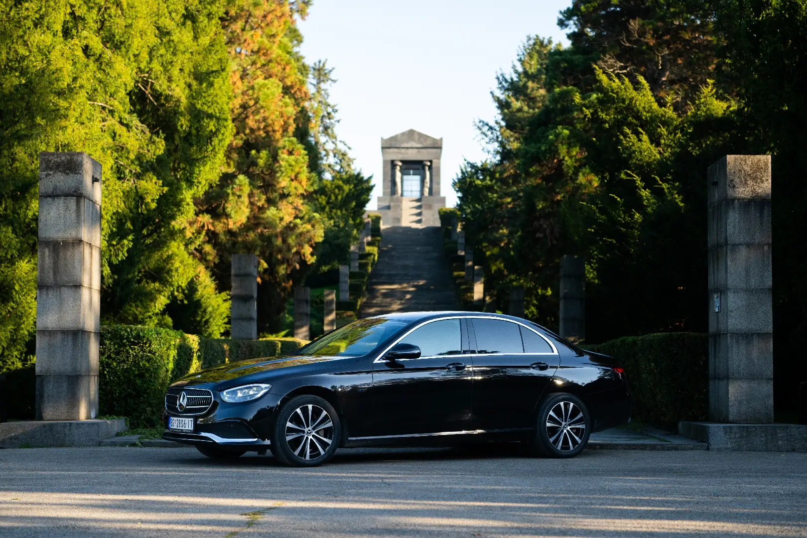 Black Mercedes-Benz E-Class viewed from the front and side.
