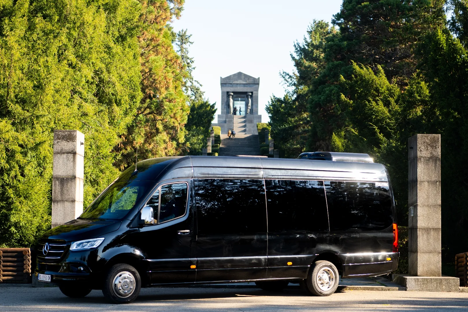 Black Mercedes-Benz Sprinter viewed from the front and side.